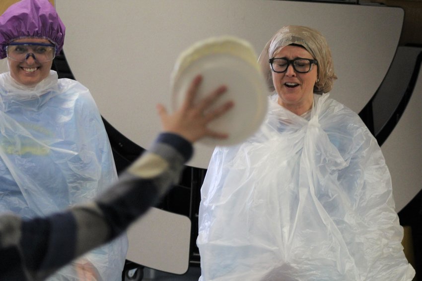 Welchester Elementary School Assistant Principal Jennine Tarpley and Principal Bethany Robinson prepare to be hit with a serving of whipped cream during a Dec. 2 assembly. The two students and teacher who sold the most pastries during a recent fundraiser won the honor of "pieing" Tarpley and Robinson.